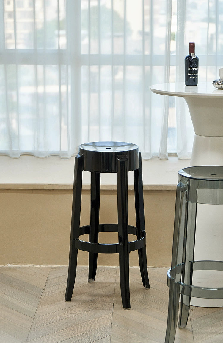 A stylish, modern bar stool with a sleek design, featuring a comfortable seat and sturdy legs, suitable for contemporary kitchen or bar settings.