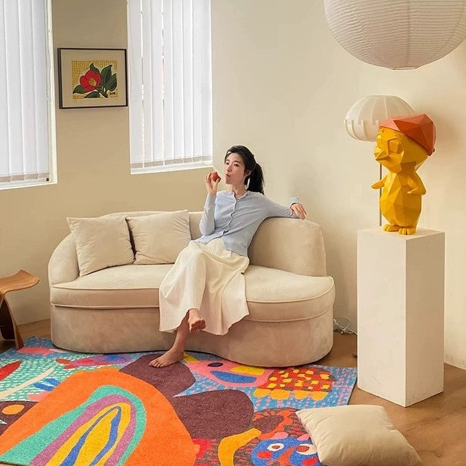 Cozy living room with a gray couch, colorful throw pillows, a white coffee table, and potted plants, creating a welcoming, renter-friendly decor style.