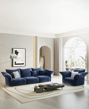 Cozy living room with a gray couch, colorful throw pillows, a white coffee table, and potted plants, creating a welcoming, renter-friendly decor style.