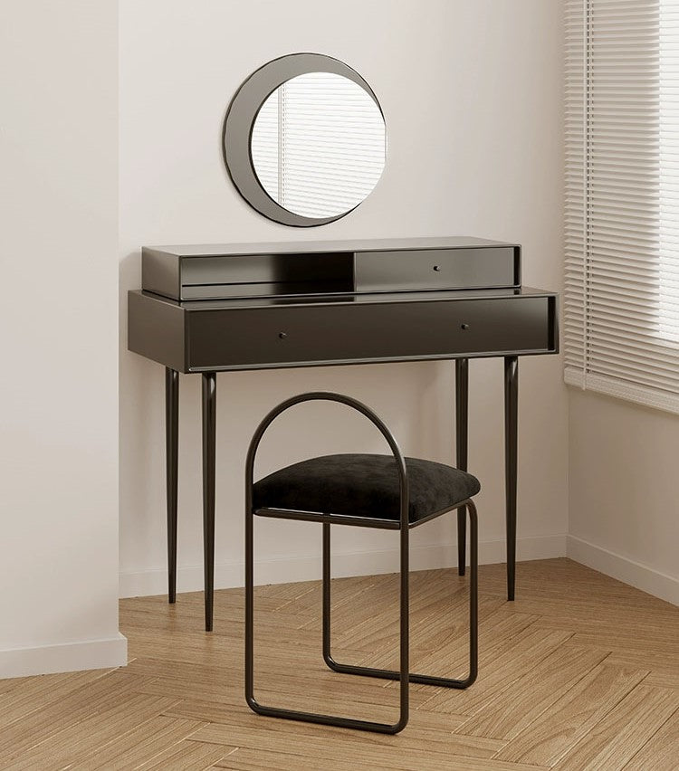An elegant vintage dressing table with ornate carvings, curved legs, a tri-fold mirror, and antique brass handles, placed in a cozy, softly lit room.