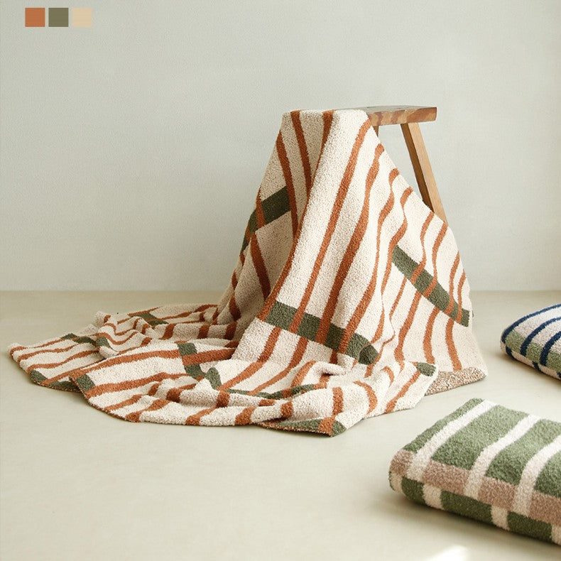 Textured blankets adding warmth to a minimalist decor