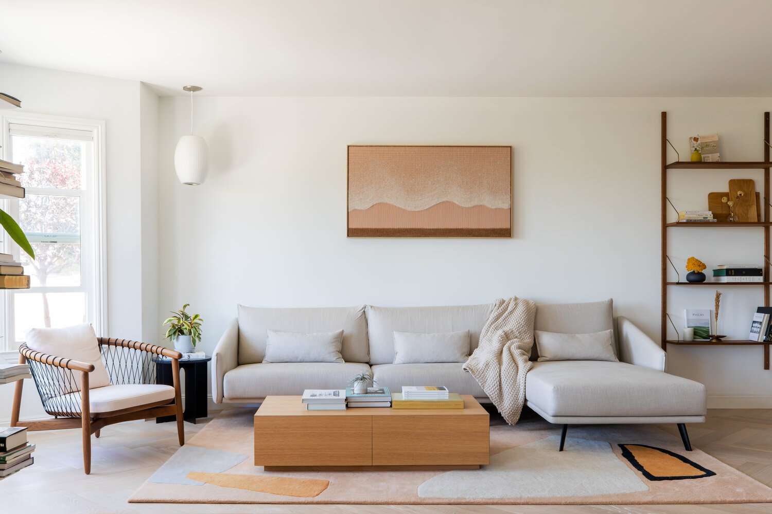 A minimalist apartment with a foldable dining table and a storage ottoman, showcasing space-saving furniture ideas for renters.